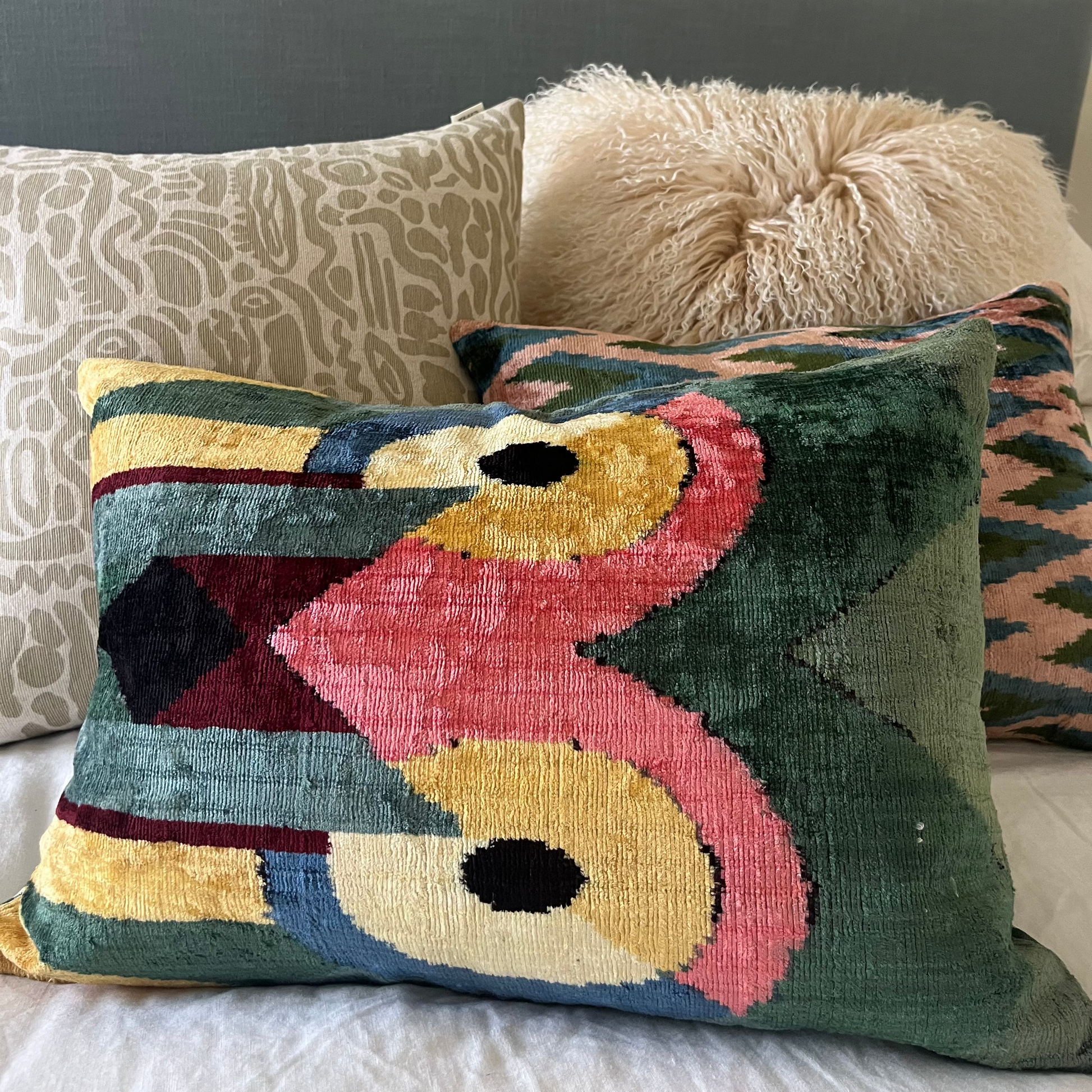 Decorative pillow with abstract design on a bed